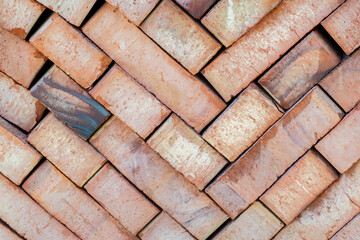 Lot of red ceramic bricks backdrop at construction, building site