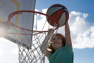 Kids playing basketball. Child sport activity. Healthy children lifestyle. Closeup face of kid...