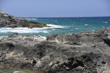 yhe waves crashing on the rocks
