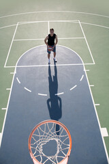 Basketball player. Sports and basketball. Man jumps and throws a ball into the basket.