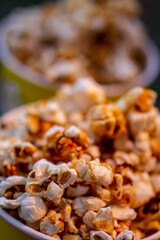 two glasses of homemade caramel sweet popcorn as a detailed close-up shot, selective focus.