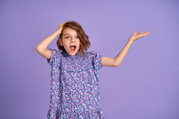 Photo of nice amazed little girl isolated on lavender, purple color background. 