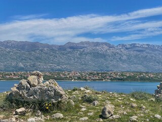 LJUBAČ, CROATIA, May 2021 - Remains of old church at the Ljubljana archaeological site and view toward Velebit mountain and Rtina