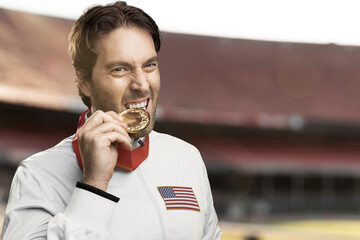 American  male athlete smiling after winning a gold medal in a white background