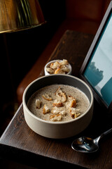 Studio shot of mushroom soup with cream and wheat bread studio advertisement shot