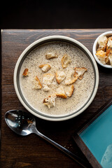 Top view of mushroom creamy soup and fresh white bread