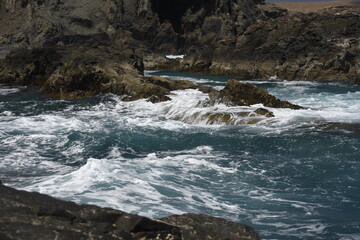 yhe waves crashing on the rocks
