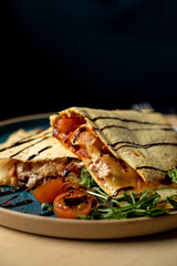 Close up of quesadilla with grilled chicken breast and chili sauce, neat restaurant photo
