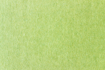 A sheet of green colored paper. Rough smooth texture.
