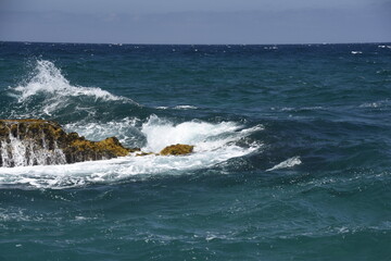 yhe waves crashing on the rocks