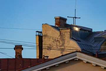 Chimneys on the roofs of old buildings in St. Petersburg.
