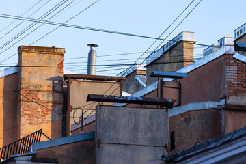 Fototapeta na wymiar Chimneys on the roofs of old buildings in St. Petersburg.