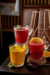 Seasonal berry autumn drinks in a coffee shop side view on a dark background