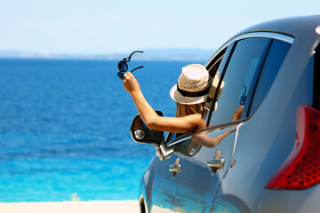 driver in car at sea in summer