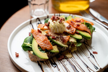 Salmon sandwich in a dark restaurant, elegant advertisement photo