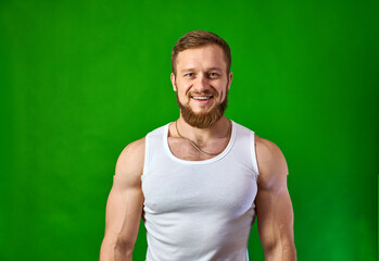 man smile white shirt stands and looks at camera. Hands to side. Body rotation.