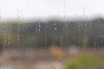 Close-up view of rain drops on dirty window. Blurred background. Copy space for your text. Cleaning service theme.