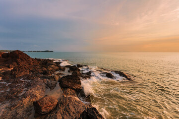 Beautiful sunset on the rock beach.