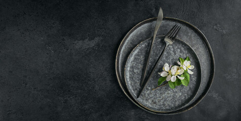 Place table setting with blossoming apple tree branches and flowers