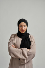 Portrait of pretty young arabian girl in black hijab