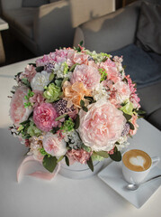 Floral bouquet in hat box. Beautiful delicate pink and white flowers in hat gift box grey color.
