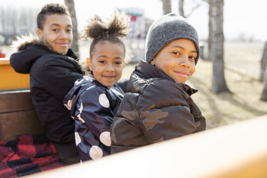 Portrait cute brothers and sister in truck bed
