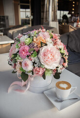 Floral bouquet in hat box. Beautiful delicate pink and white flowers in hat gift box grey color.