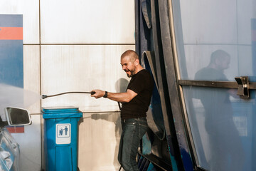 Man washing his car on self service car washing station