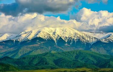 Fototapeta premium Landscape with Fagaras mountains covered with clouds and snow