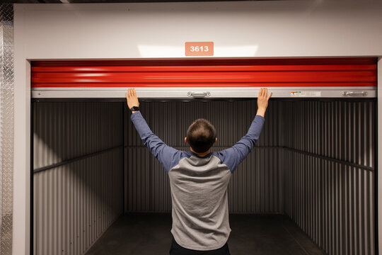 Man Opening Empty Storage Facility Locker