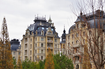 The building on the palace embankment in the foreground trees, spring cloudy day. Russia Kazan 24.04.2021. High quality photo
