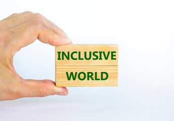 Inclusive world symbol. Wooden blocks with words Inclusive world on beautiful white background. Businessman hand. Business, inclusive world concept. Copy space.