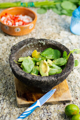 Traditional mexican guacamole made in a molcajete