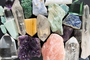 Background of crystals and gemstones. Colorful gemstones and beautiful crystals on dark texture