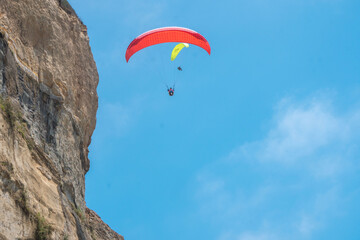 Paraglider by ocean cliffs