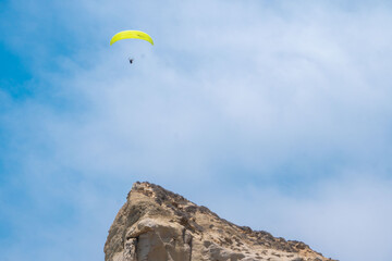 Fototapeta na wymiar Paraglider by ocean cliffs