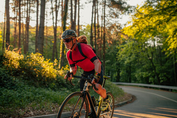 Man carrying dog in backpack pet carrier on a bike trip