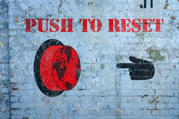 Push to reset world graffiti on grungy wall, the great reset concept