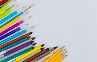 A different colored stationery in stands on a variety school supplies