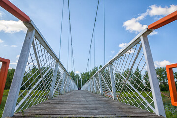 Low view of white suspended bridge