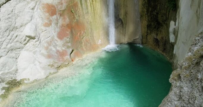 Panning shot of small waterfall of Nidri and natural pool with emerald water.