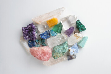 Crystals and gemstones on a w ite background. Flat lay of colorful gemstones and crystals.