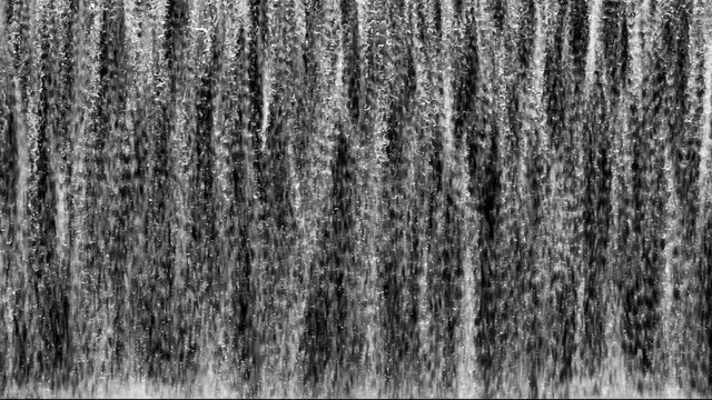 Waterfall 4K Loop is a magnificent stock motion graphics video that shows black and white waterfalls that flow vigorously. Water splashes from the bottom of the screen. This 3840x2160 (4K) bit of foot