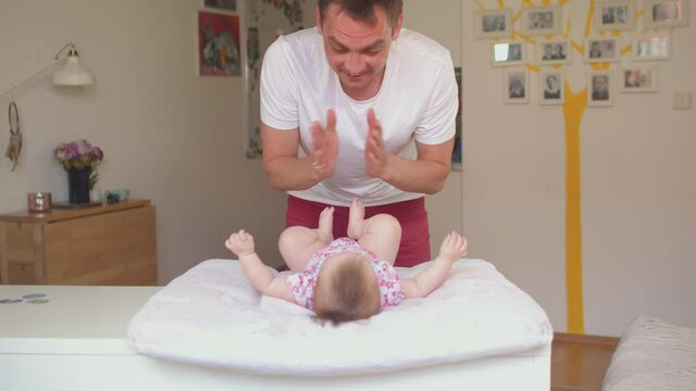 An active father makes a gymnastic with a little girl. He makes his hands, he raises the tone of his body. It is perceptive of the hands, the delineation of senses.