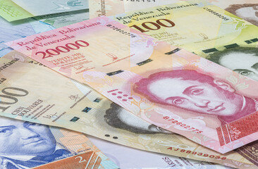 Close up to the currency of the south American country Venezuela. High inflation and weak economy increases the denomination of the banknotes. Bolivares or Bolivar money of the republic Venezuela  - obrazy, fototapety, plakaty
