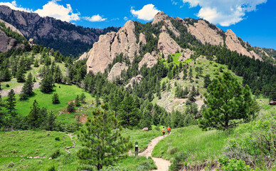 Hikers in Boulder, Colorado head towards the Rocky Mountain foothills.