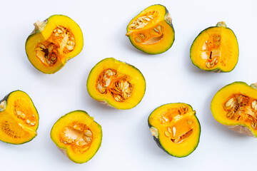 Green pumpkin pieces on white.