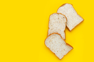Fototapeta na wymiar Bread slices on yellow background.