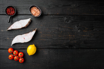 Sliced Halibut fish, with ingredients and rosemary herbs, on black wooden table background, top view flat lay, with copy space for text