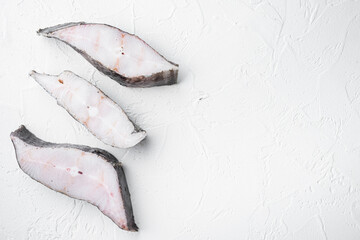 Frozen fish cut, on white stone table background, top view flat lay, with copy space for text